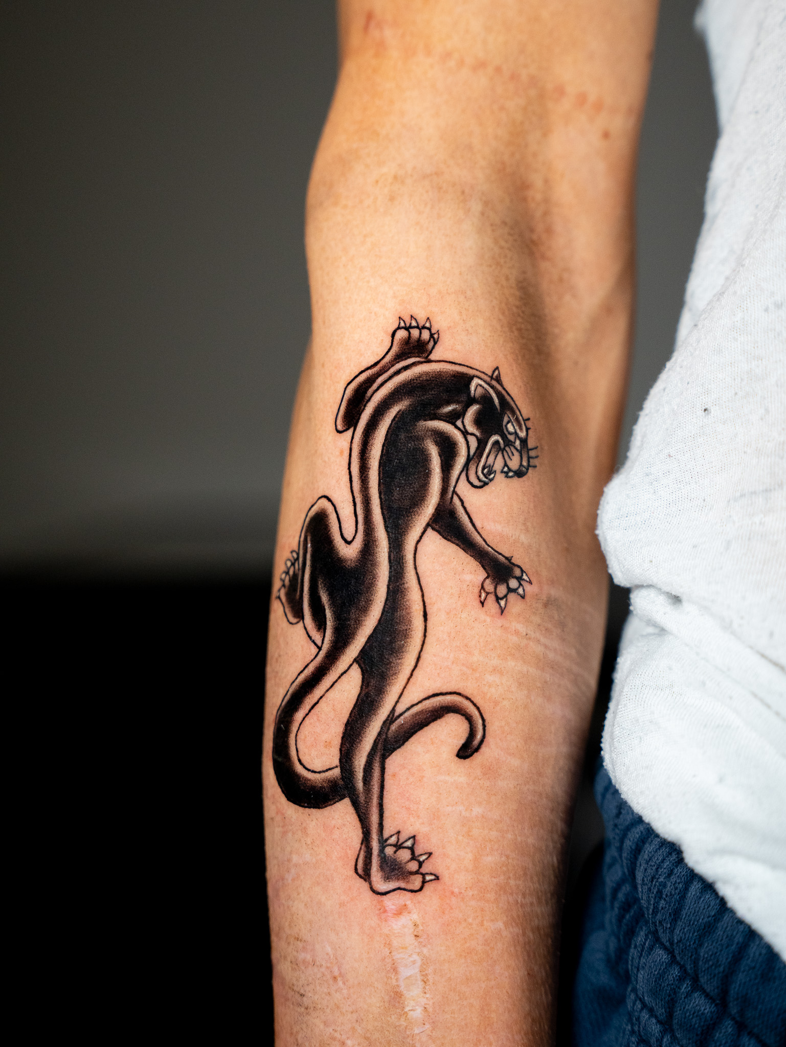 Detailed cherub tattoo on inner forearm