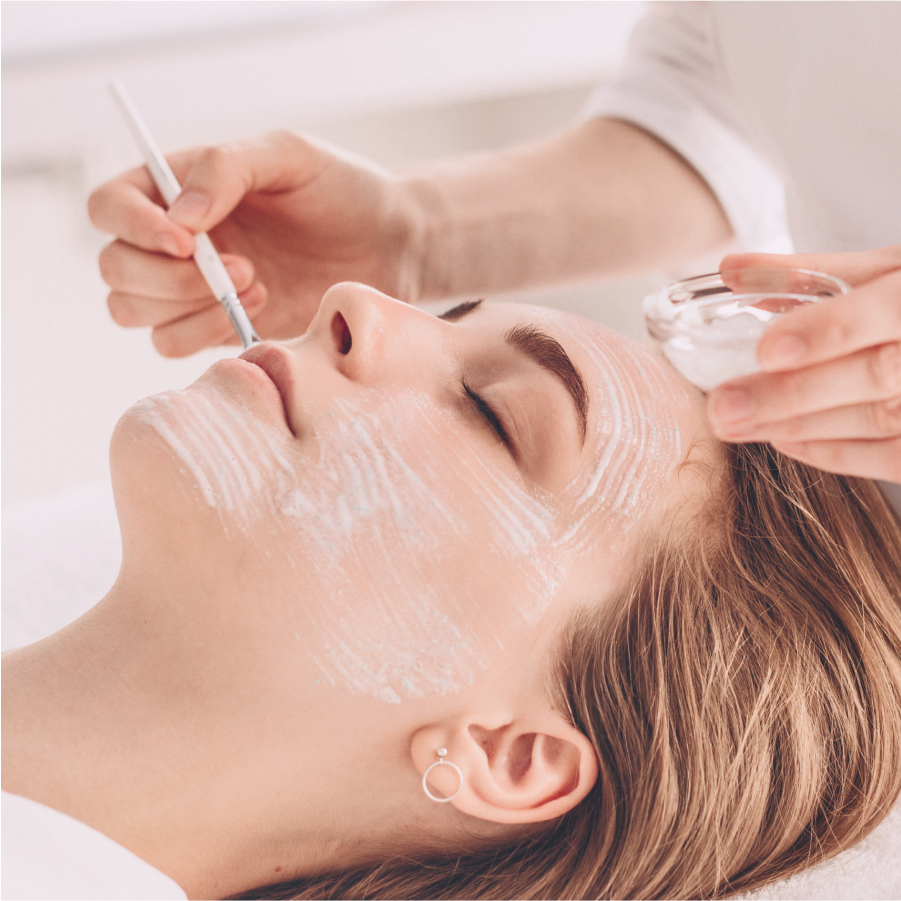 Serene expression of a woman as she enjoys a facial massage, illustrating the calming effect of the treatment