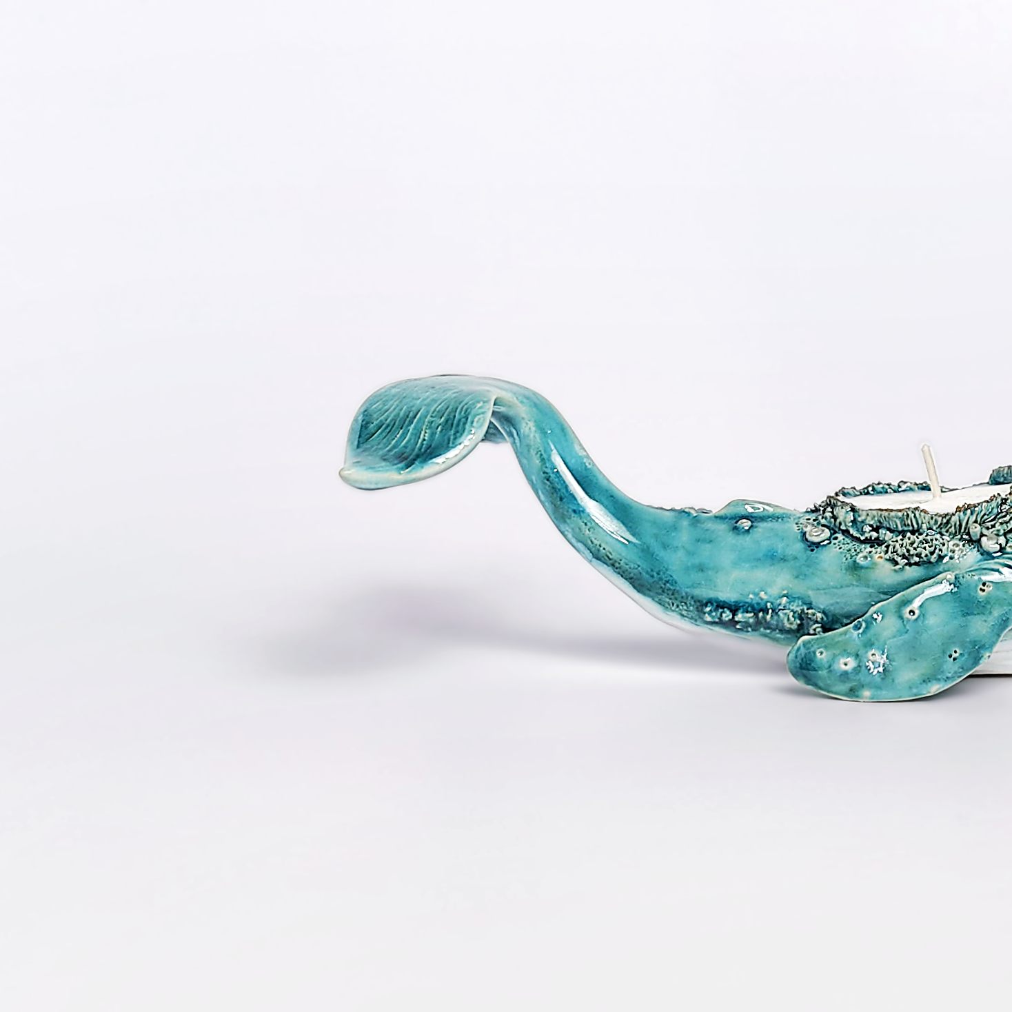 unique handmade green ceramic whale with ocean-glaze finish and detailed sculptural texture, featuring a candle inside