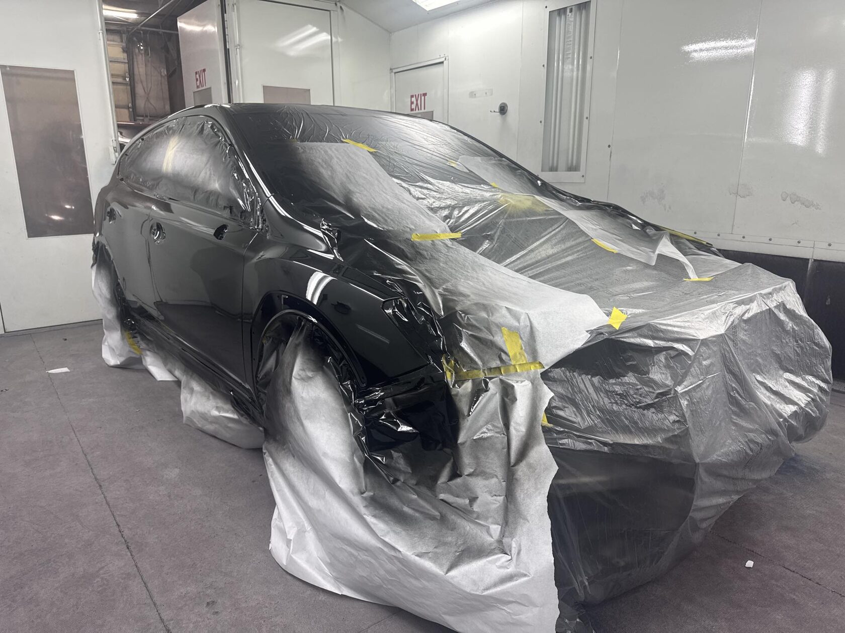 Vehicle prepared for paint inside the paint booth