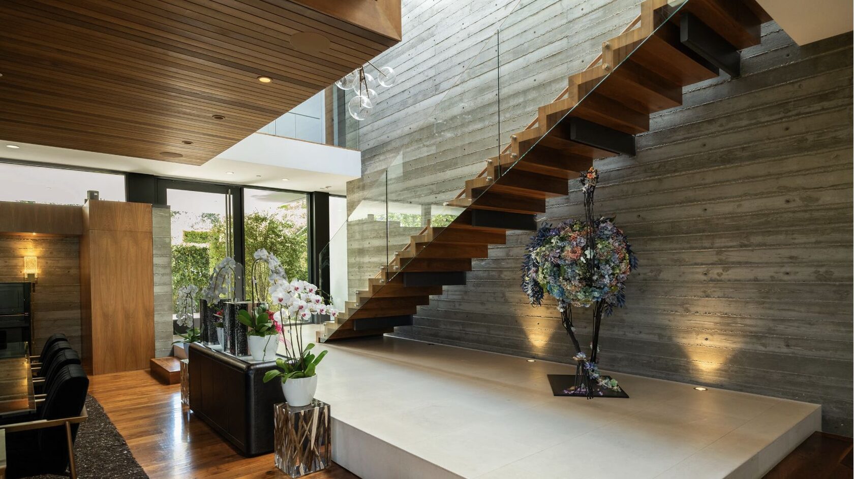 Floating wood staircase against board-formed concrete