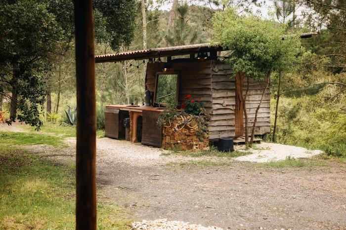 An outdoor stone bathtub among the bungalows
