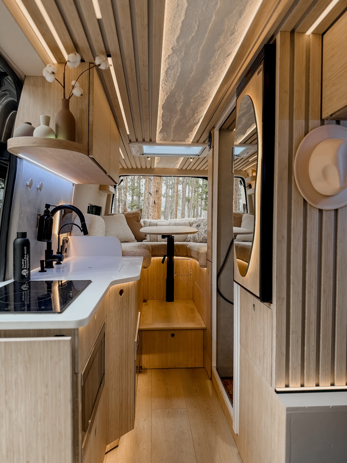 Wood and light-toned interior of a Tiny Planet van
