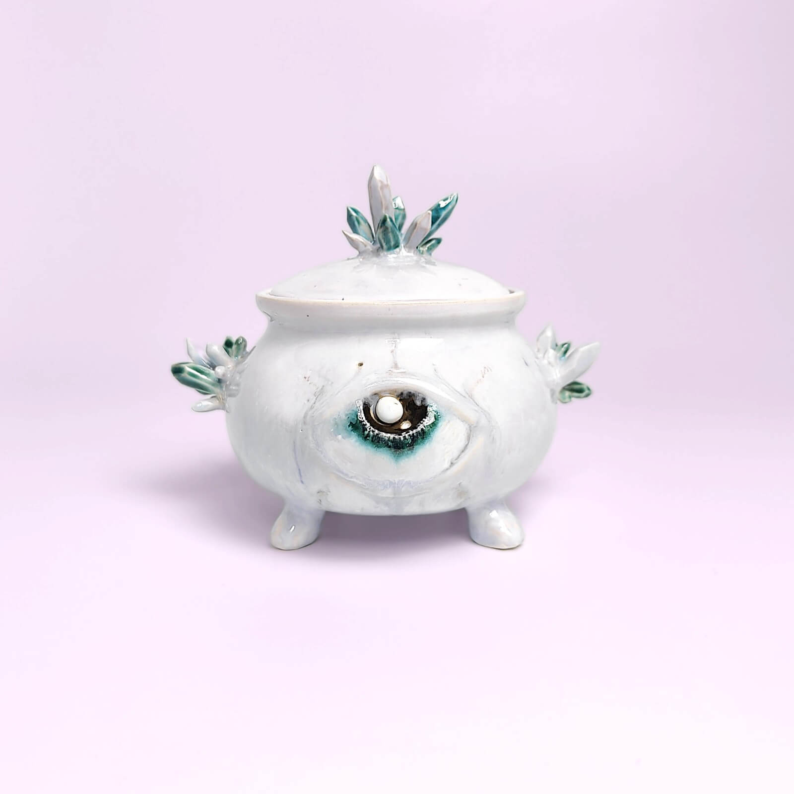 unique witchy handmade ceramic sugar bowl with a sculpted magical eye, green crystal details, and soft white glaze