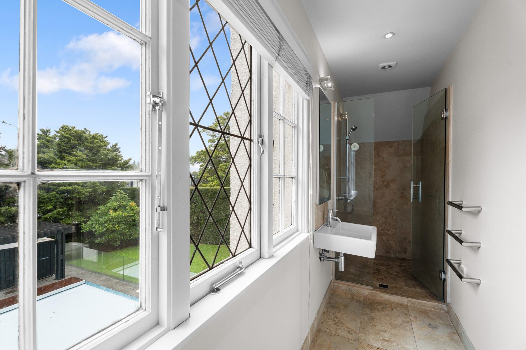 Owens Road bathroom before renovation, with the original basin and tiled shower