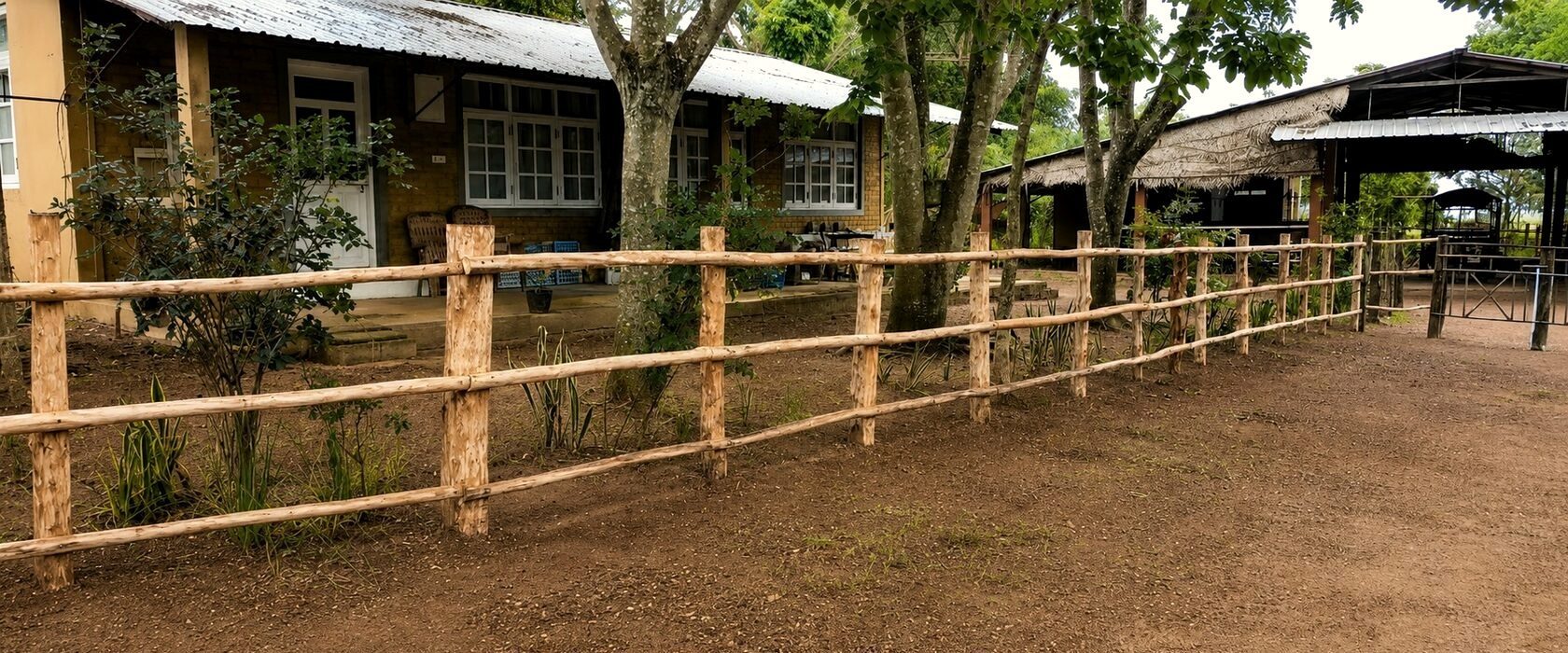 Ranch houses behind a post-and-rail fence at Punanai, eastern Sri Lanka.