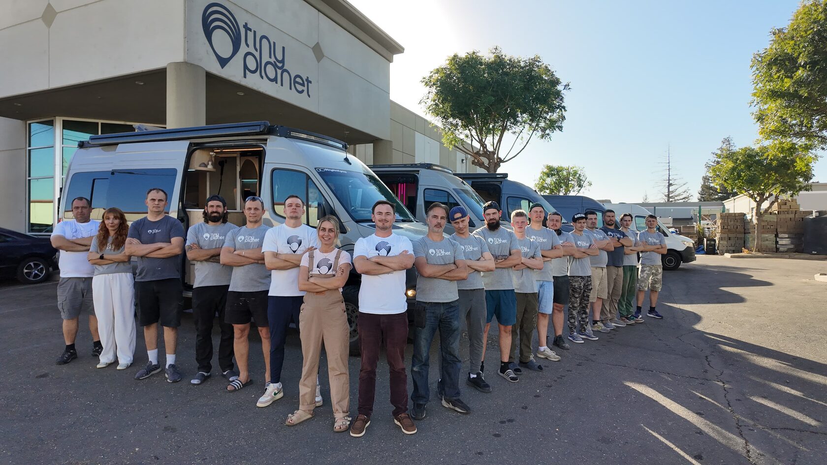The Tiny Planet team in front of the Sacramento factory with finished vans