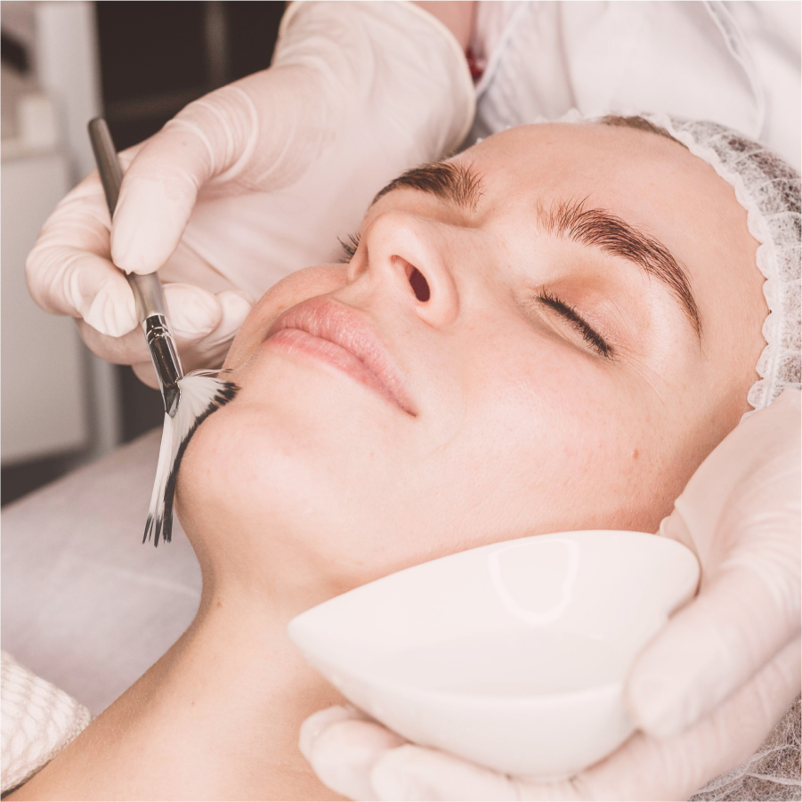 Woman with eyes closed as she experiences a soothing facial massage in a serene spa setting