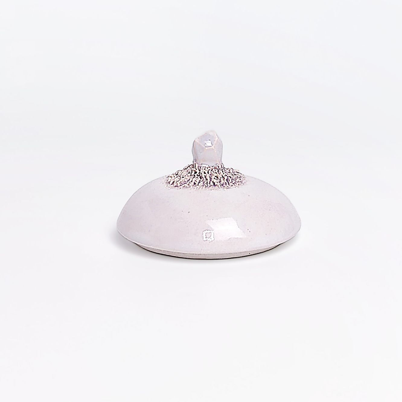 Unique handmade ceramic jar with a sculpted eye, textured crystal-like side elements, and soft pearlescent glaze