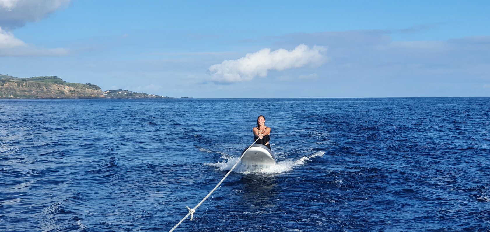 Paula being towed on a board behind the yacht