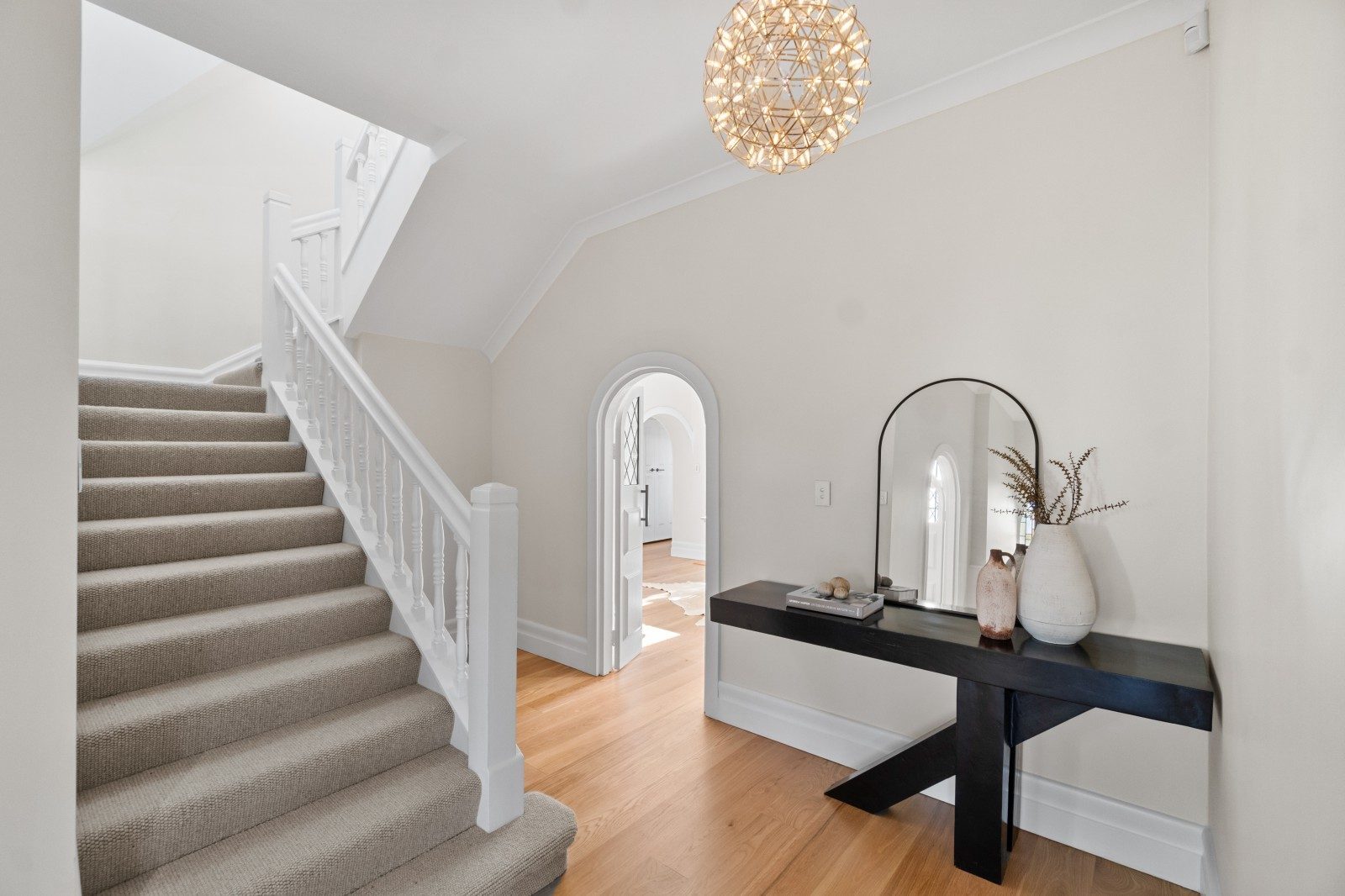 Renovated Owens Road entrance hall with a carpeted staircase, timber flooring and a pendant light