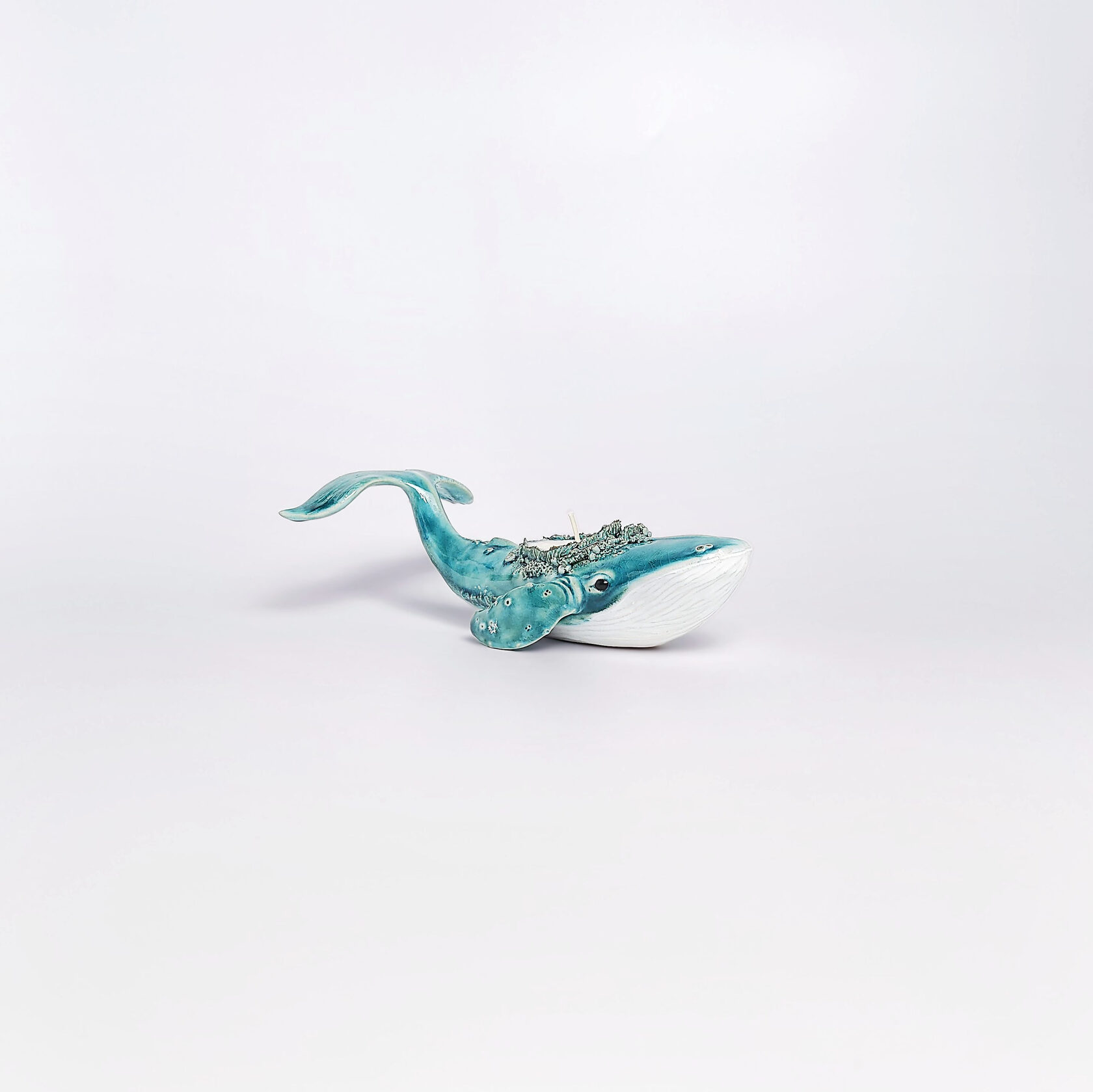unique handmade green ceramic whale with ocean-glaze finish and detailed sculptural texture, featuring a candle inside