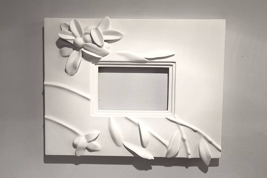 Decorative white frame with carved flowered branch 