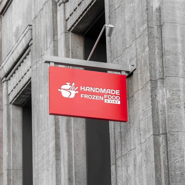 Red Handmade Frozen Food sign on a facade
