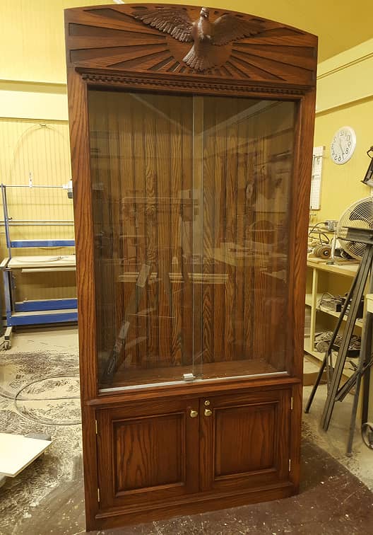 Historic church display cabinet in stained wood with hand carved dove