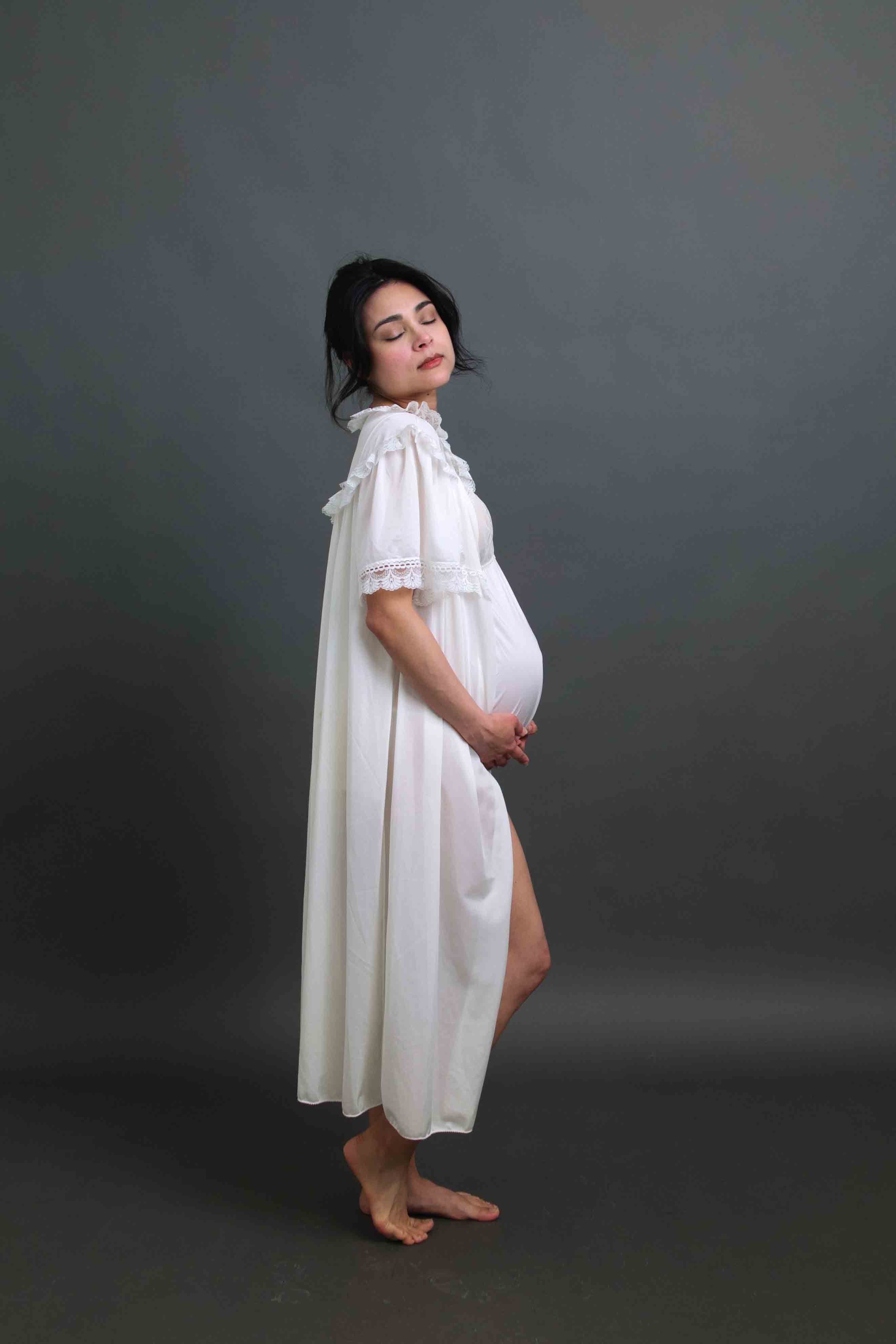 Pregnant woman creating maternity portraits in a private self-portrait studio