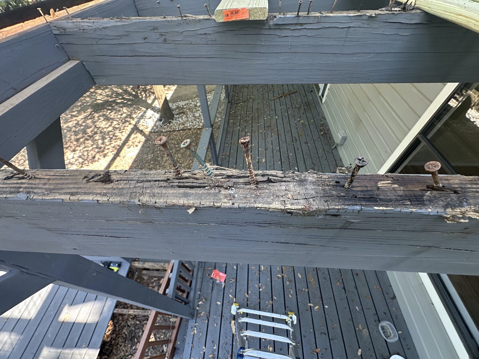 Two-level deck before renovation Lakeway TX — rotted beams and weathered surface