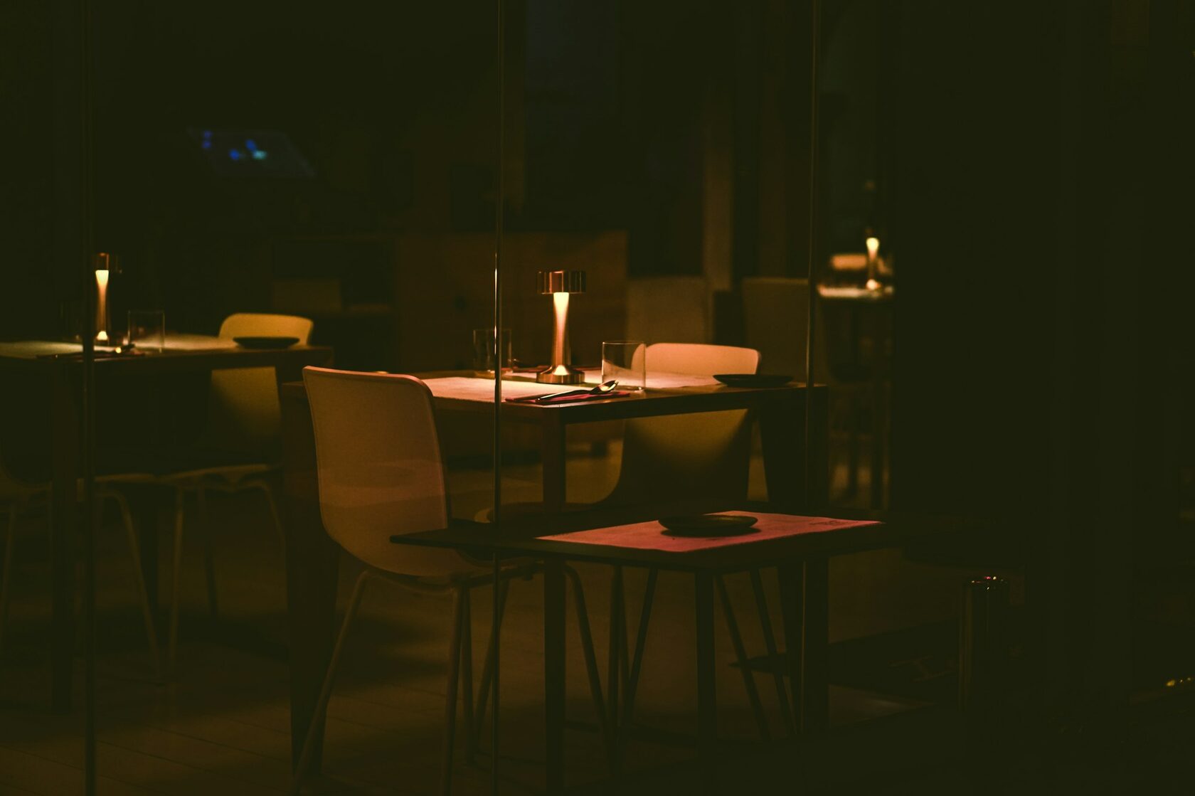 A long candlelit dinner table in a European dining room