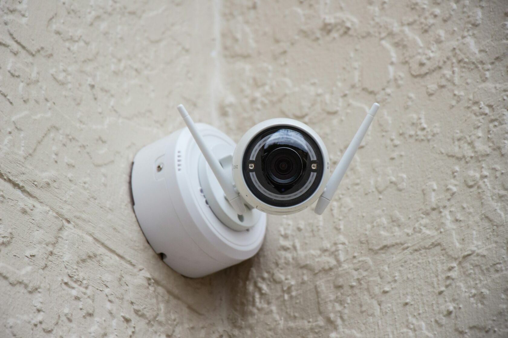 Modern white CCTV camera discreetly mounted inside a contemporary Costa del Sol home