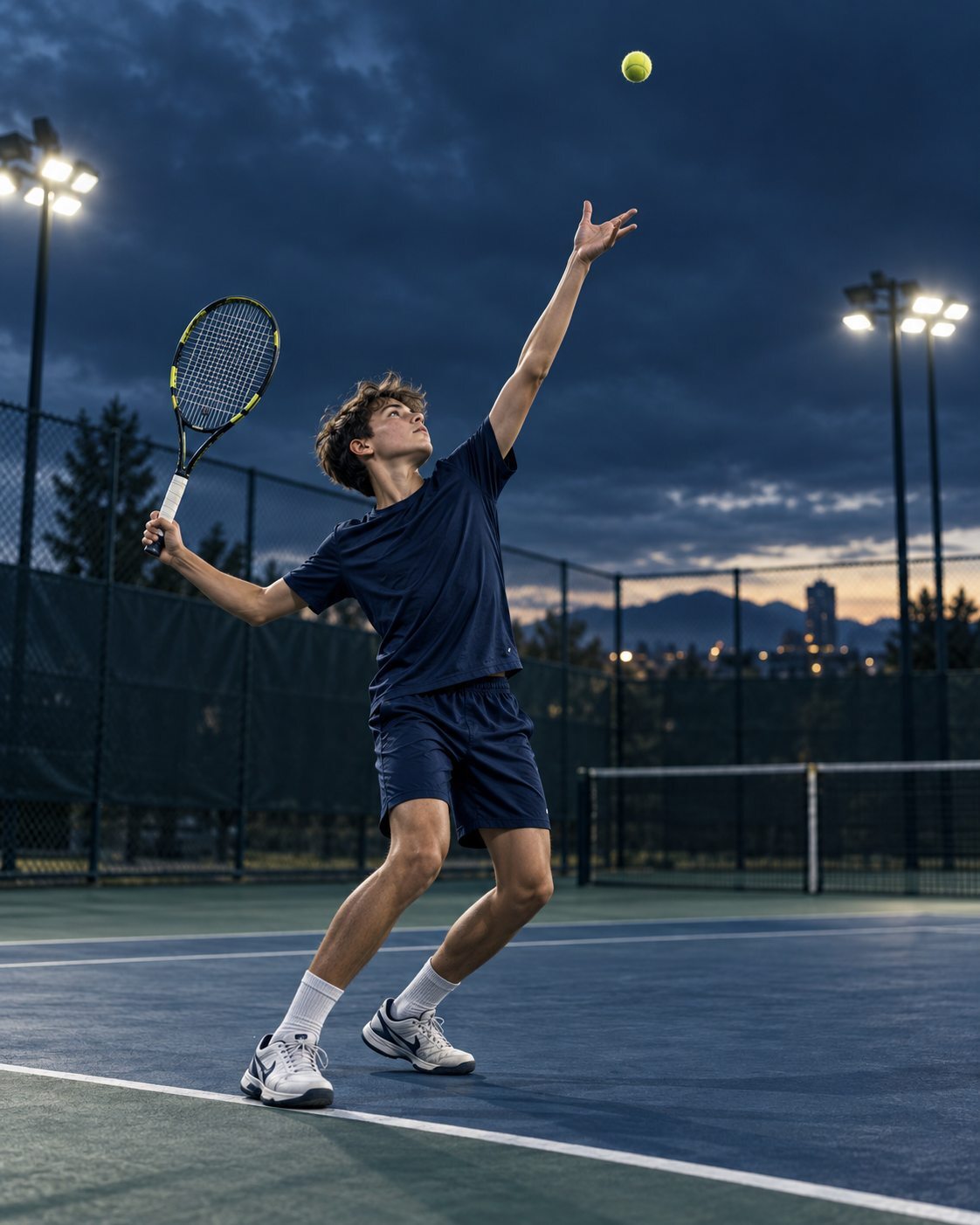 Junior competitor practicing a tennis serve at dusk