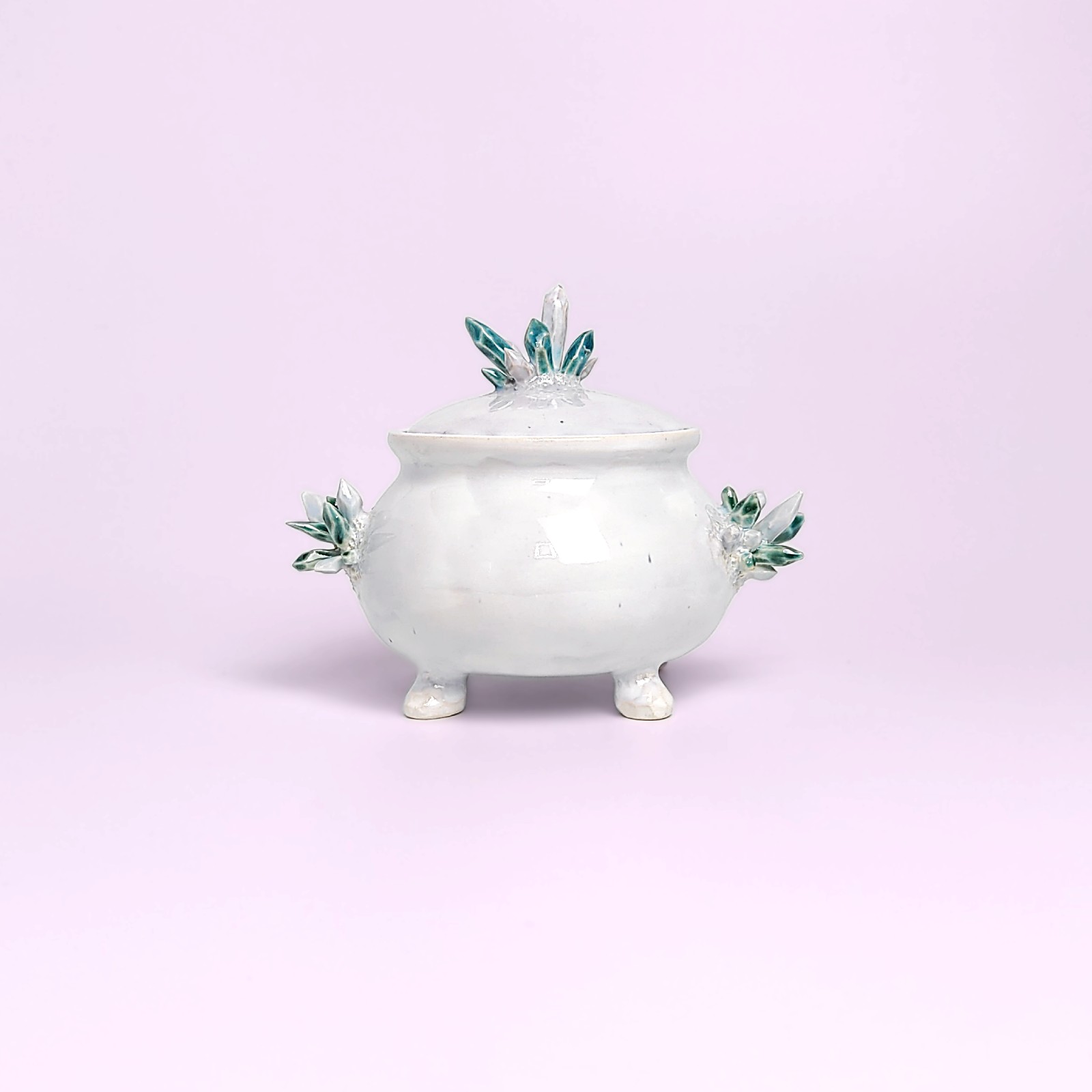 unique witchy handmade ceramic sugar bowl with a sculpted magical eye, green crystal details, and soft white glaze