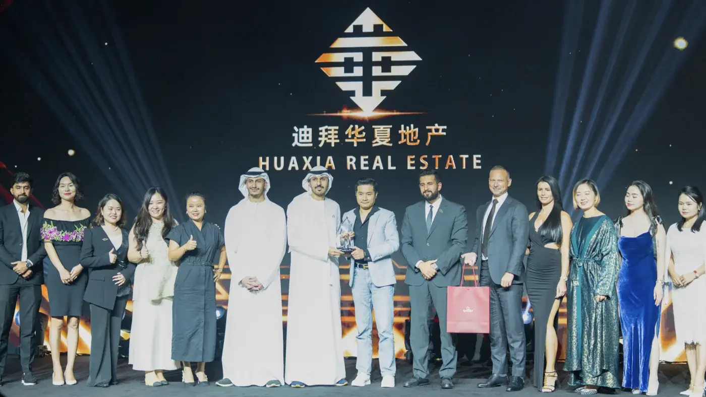 Huaxia Real Estate team receiving a developer performance award, Dubai