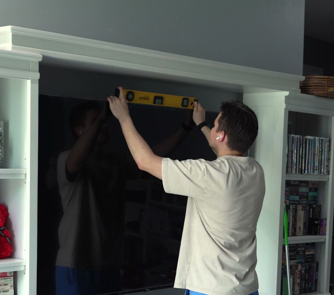 RockTV Mount technician leveling a newly mounted TV