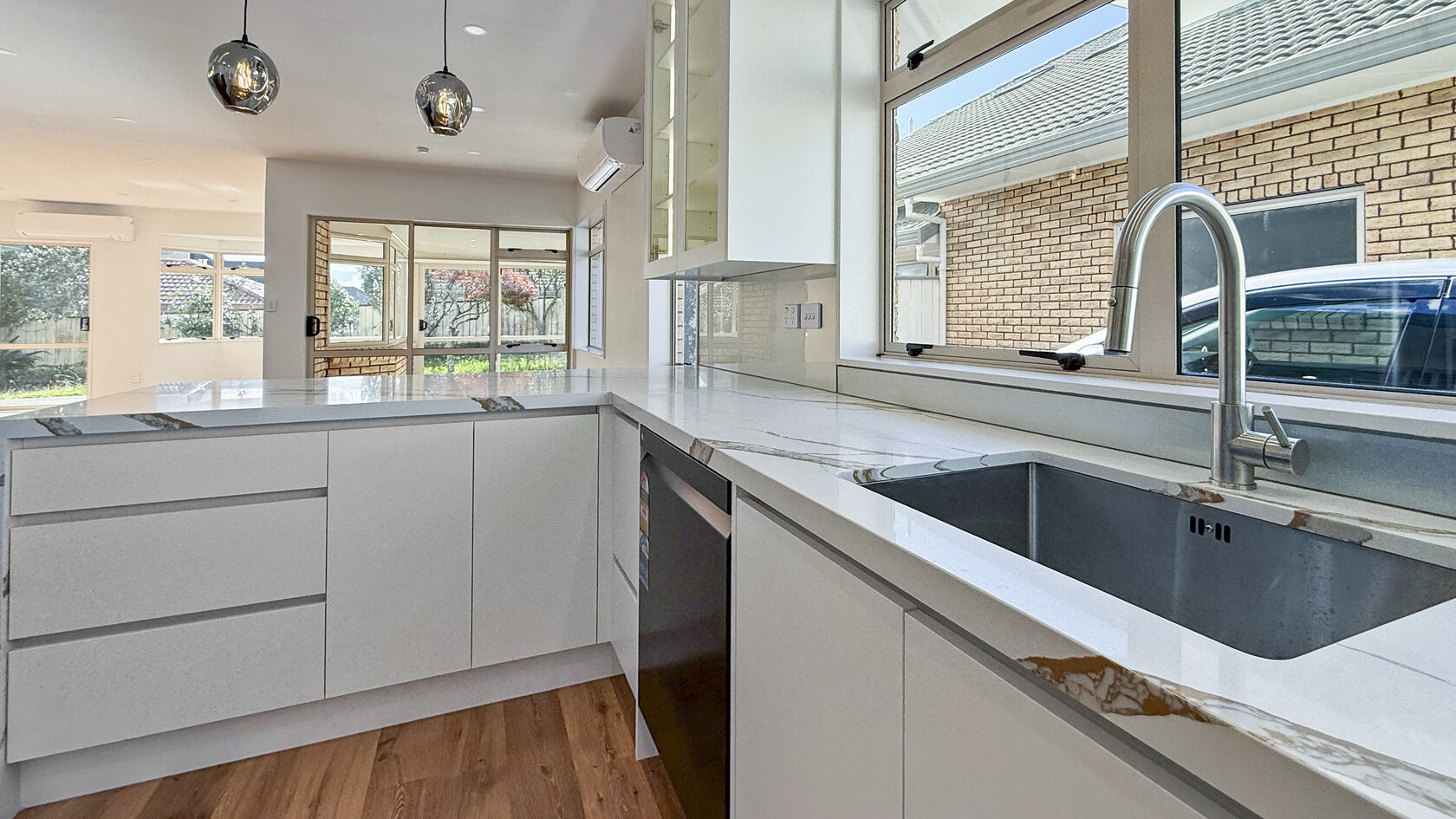 Deep undermount sink set in a marble-look worktop in the renovated St Heliers kitchen.