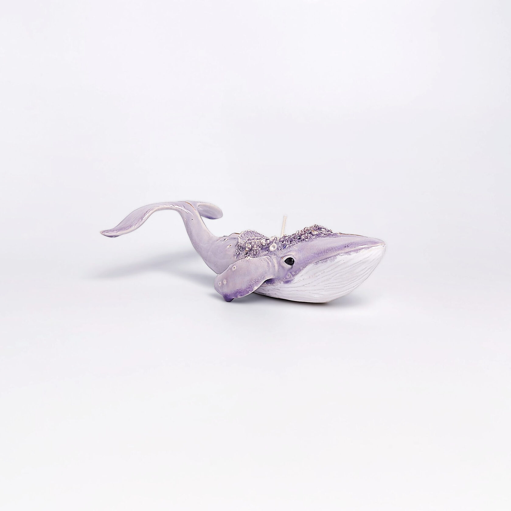handmade ceramic candle holder shaped like a purple whale with sculptural details