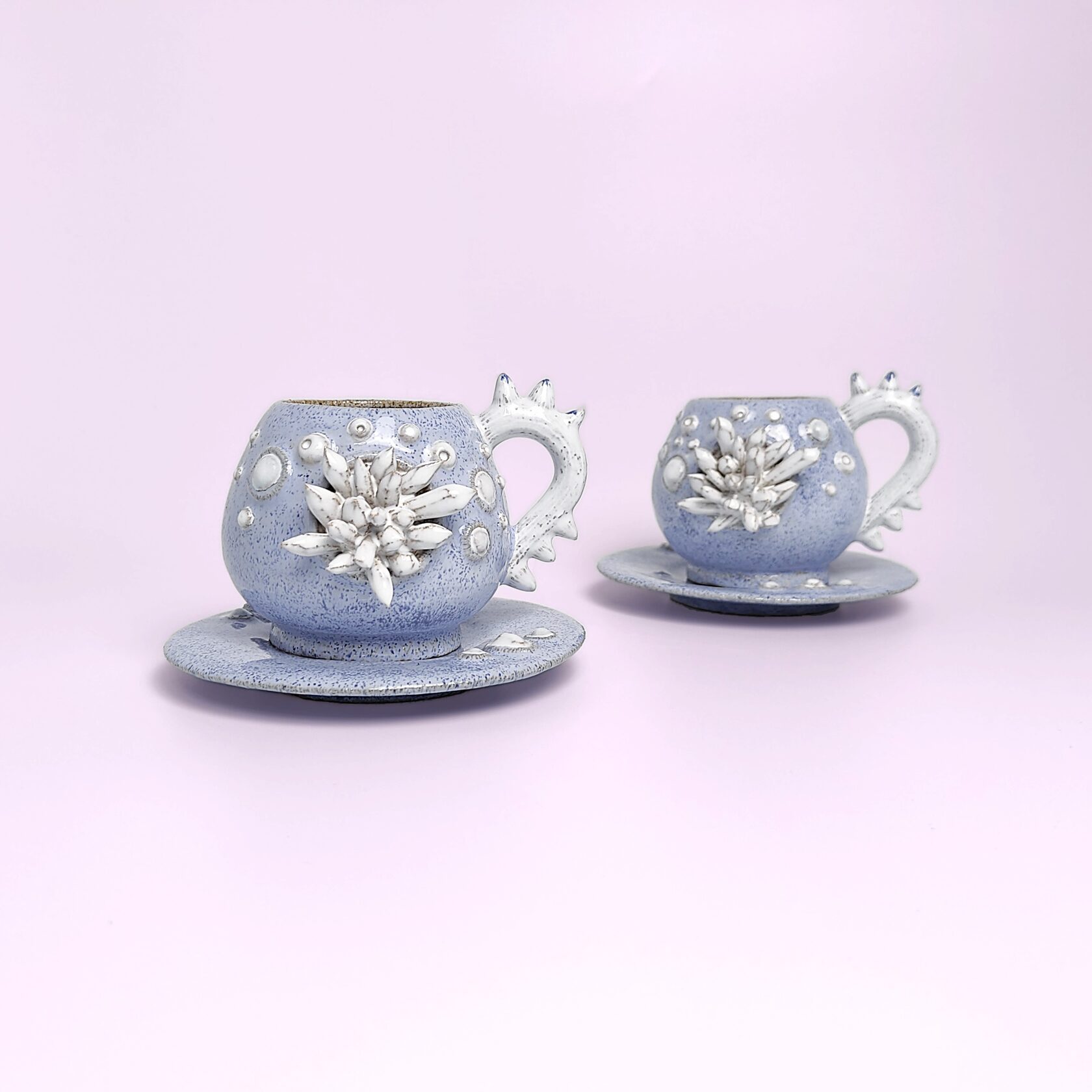 Unique handmade fairy-tale ceramic tea set shaped like a whimsical crystal-covered little monster, featuring a sculptural teapot and two matching cups with saucers