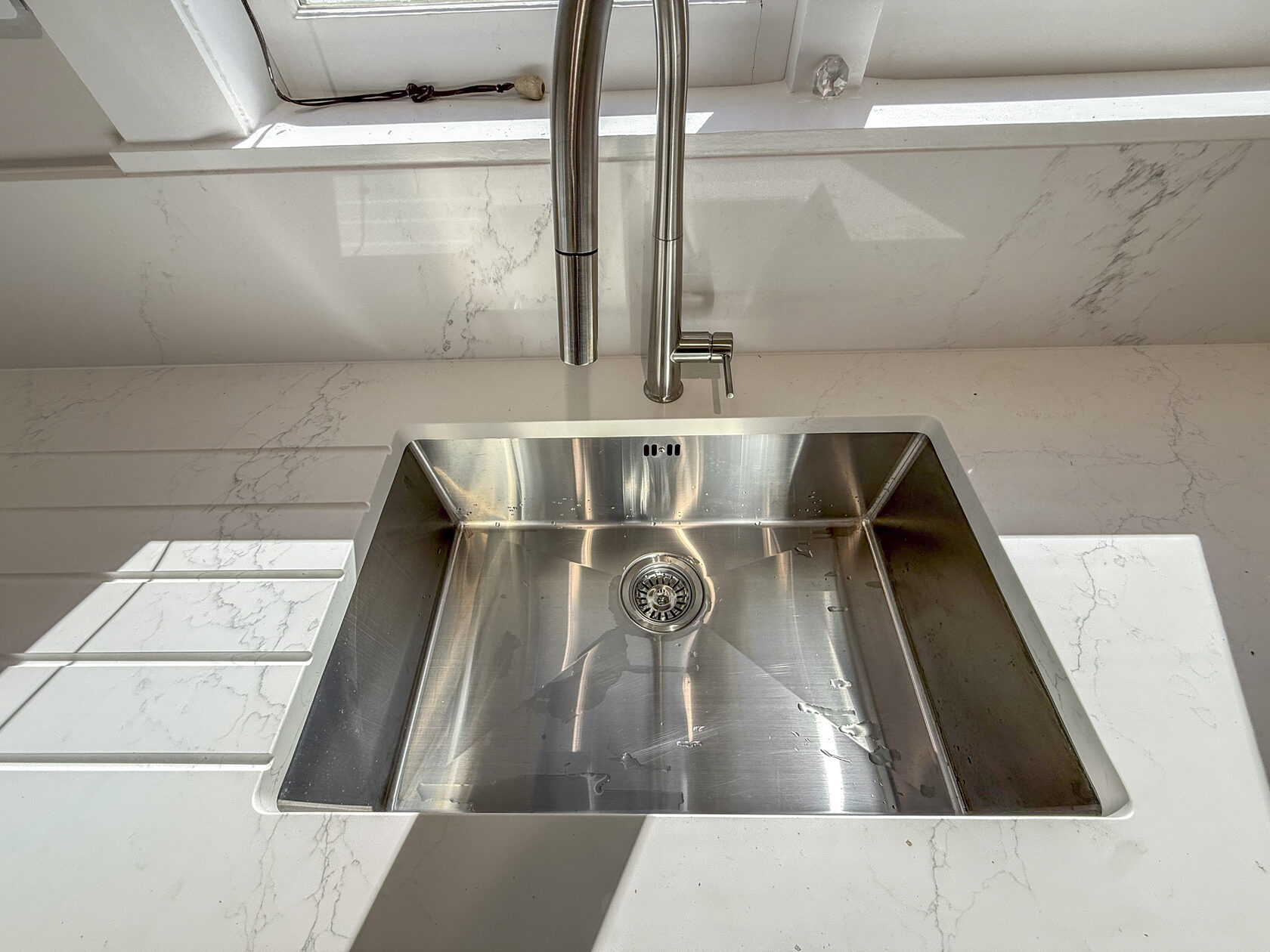 Kitchen sink, tap and worktop in the renewed Epsom bungalow