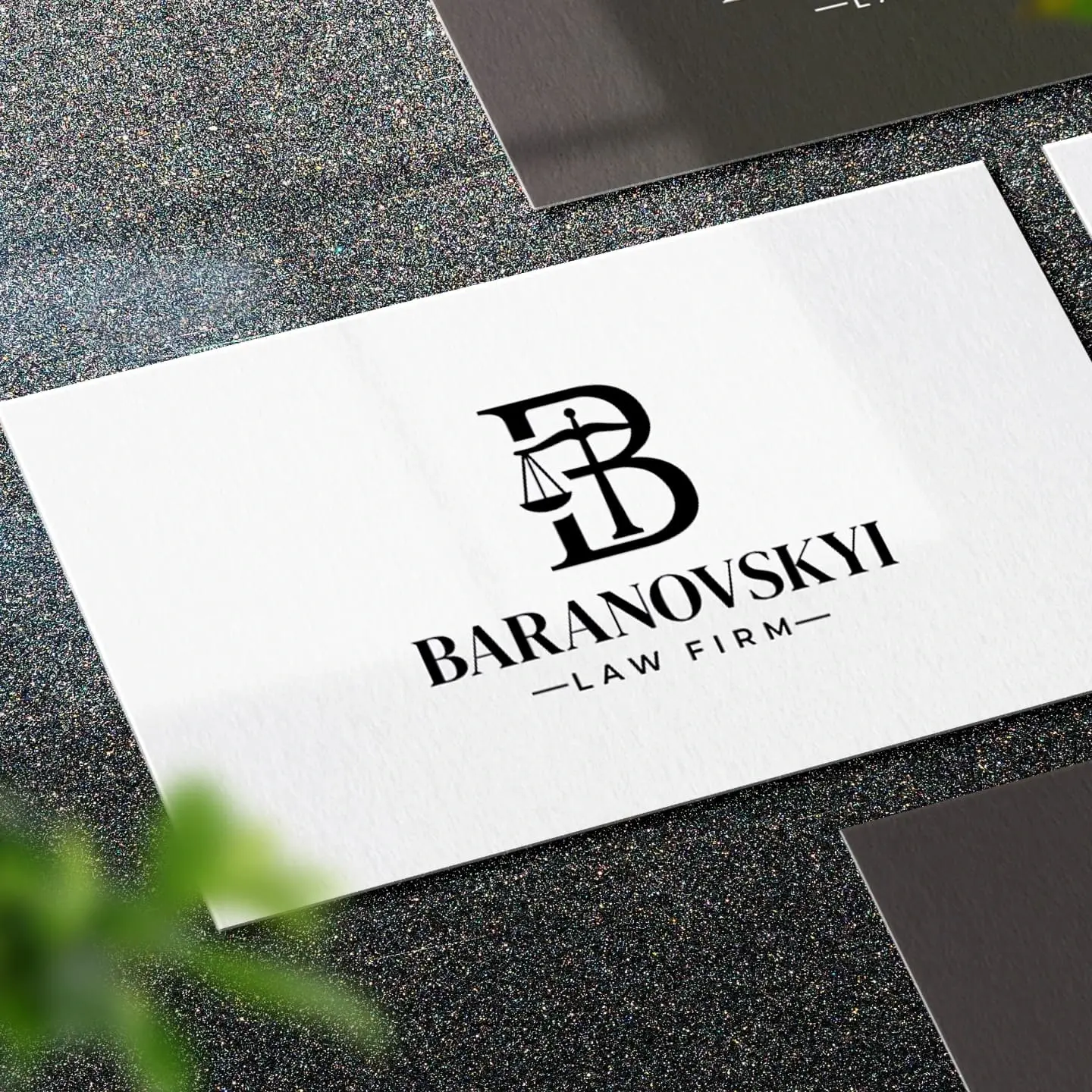 White business card with the BARANOVSKYI LAW FIRM logo