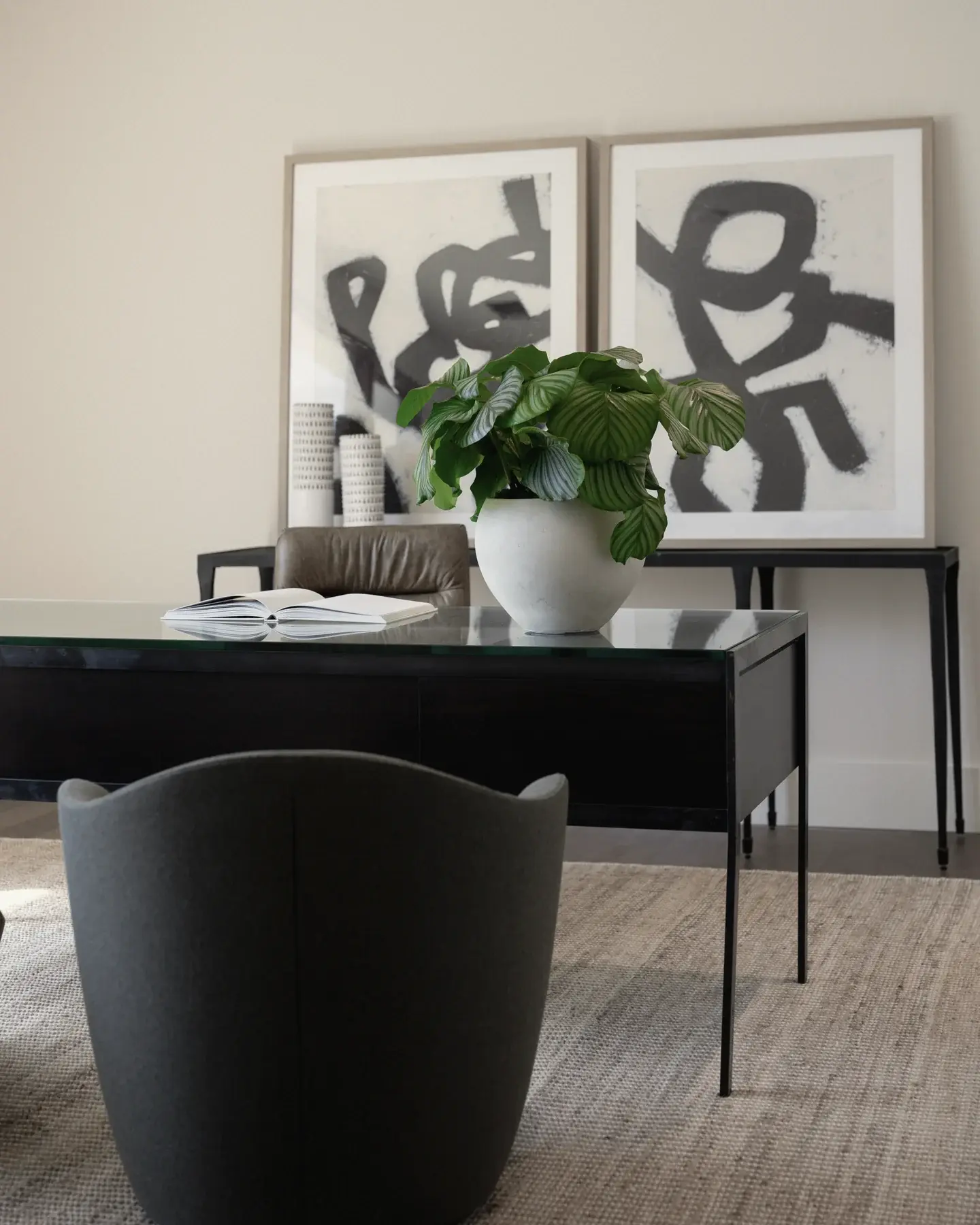 An arrangement on a desk under abstract art