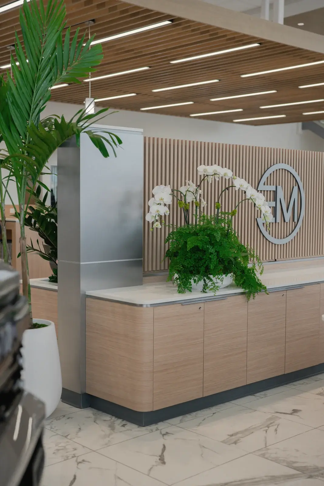 Palm and orchids at the reception desk of Toyota of West Covina