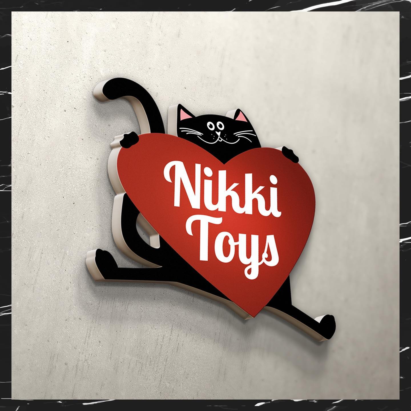 Nikki Toys toy store logo – a black cat with a red heart