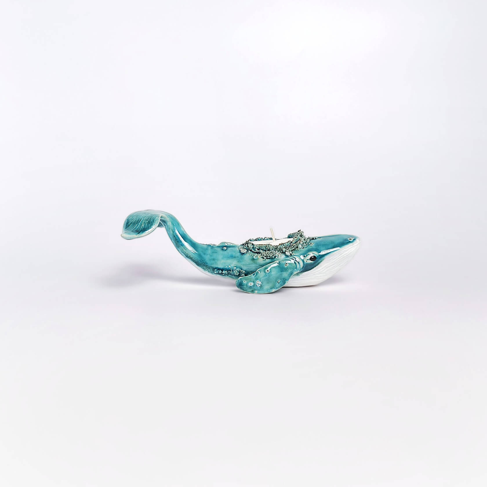 unique handmade green ceramic whale with ocean-glaze finish and detailed sculptural texture, featuring a candle inside
