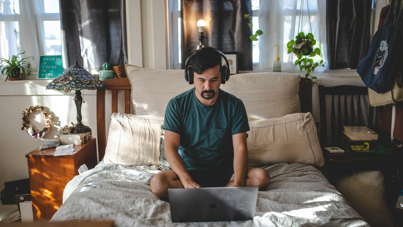 Erwin working on his laptop in a bedroom at night, beginning of ErwinAds