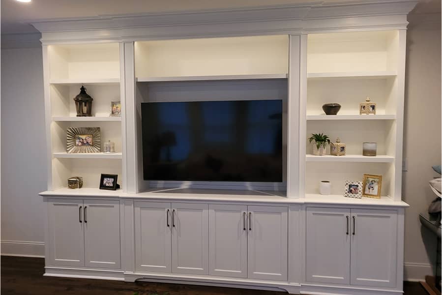 White color family room entertainment center with lighted display cabinets 