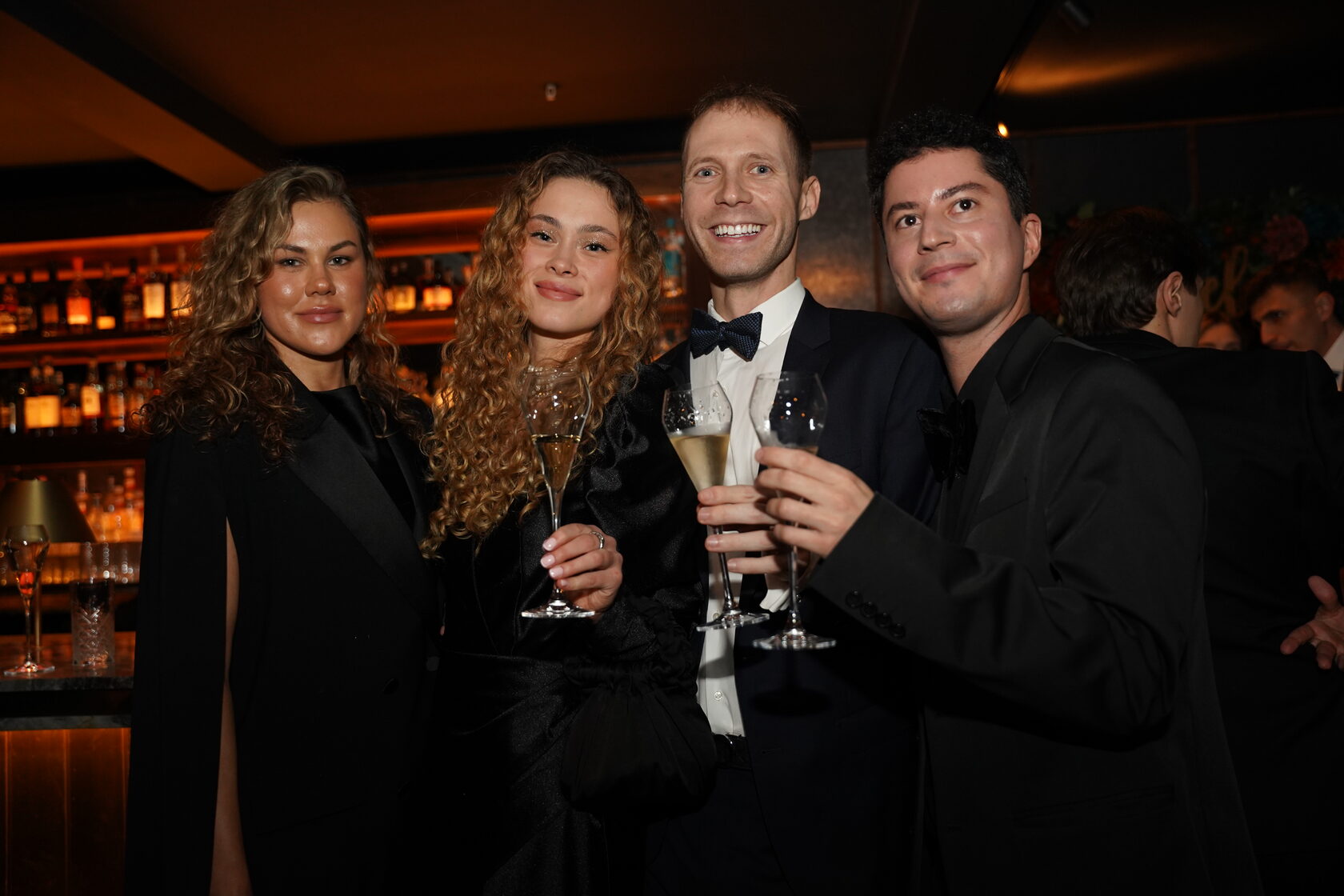 Group of guests smiling together at a reception