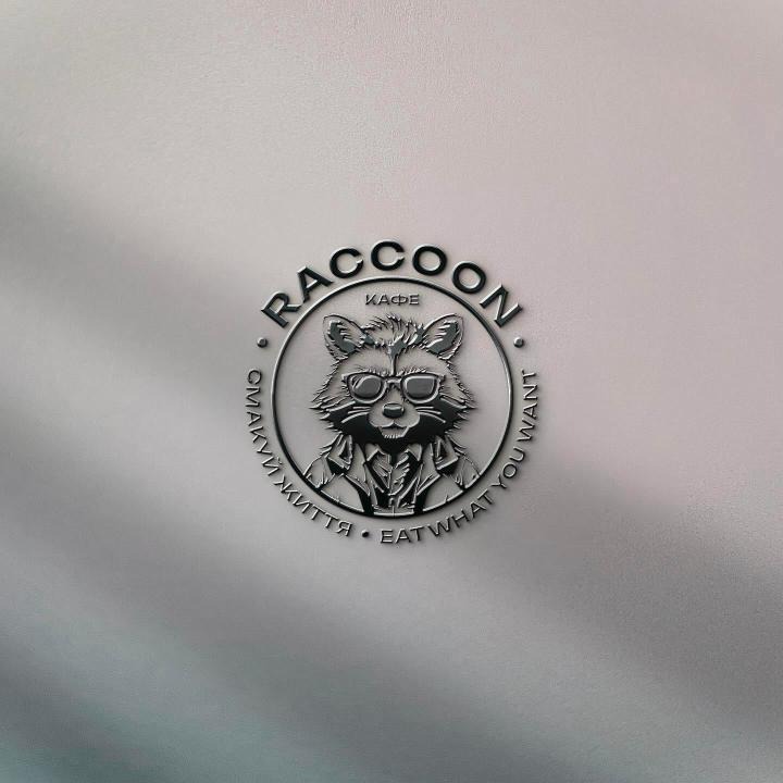 Glossy RACCOON logo on a pastel wall