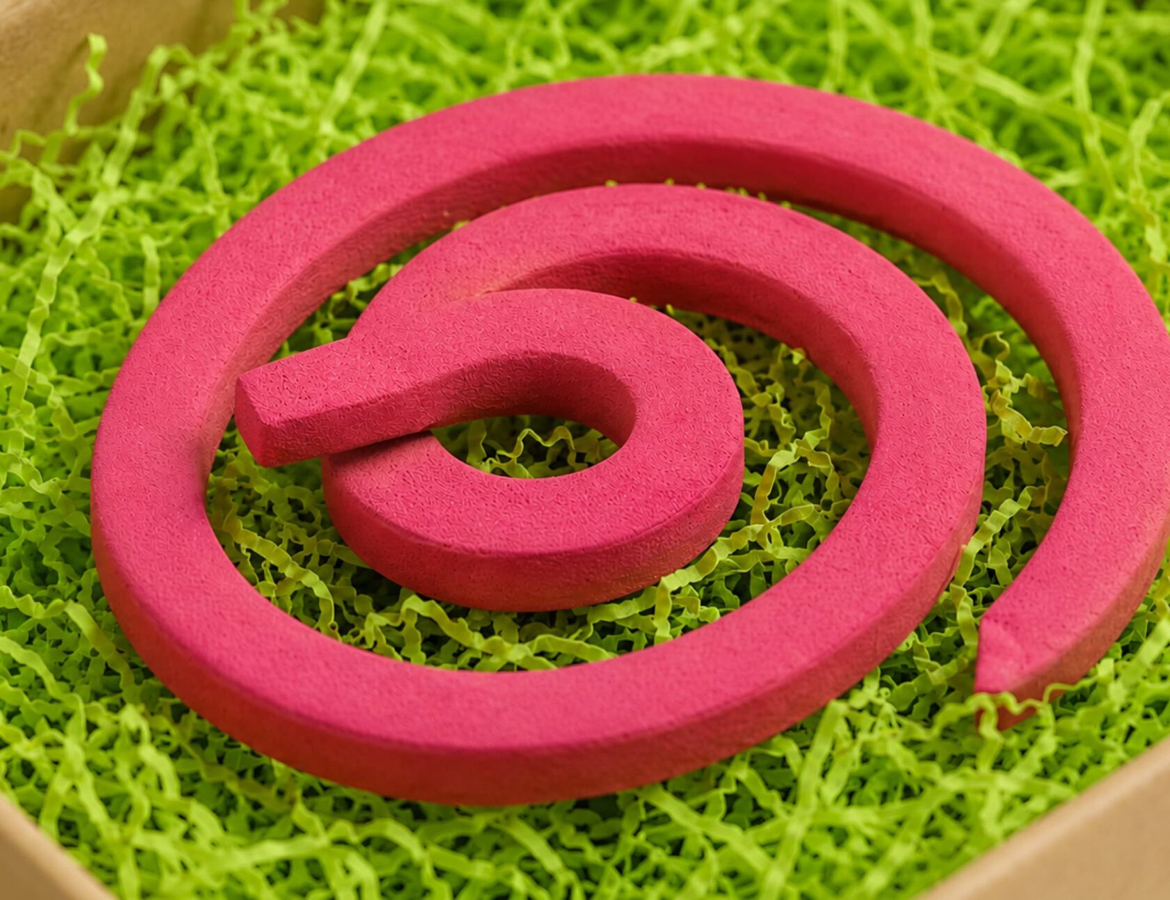 Pink mosquito coil on grass