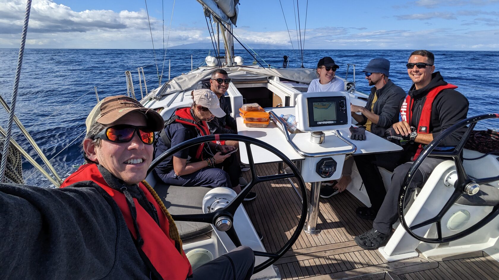 Guests at the helm while sailing