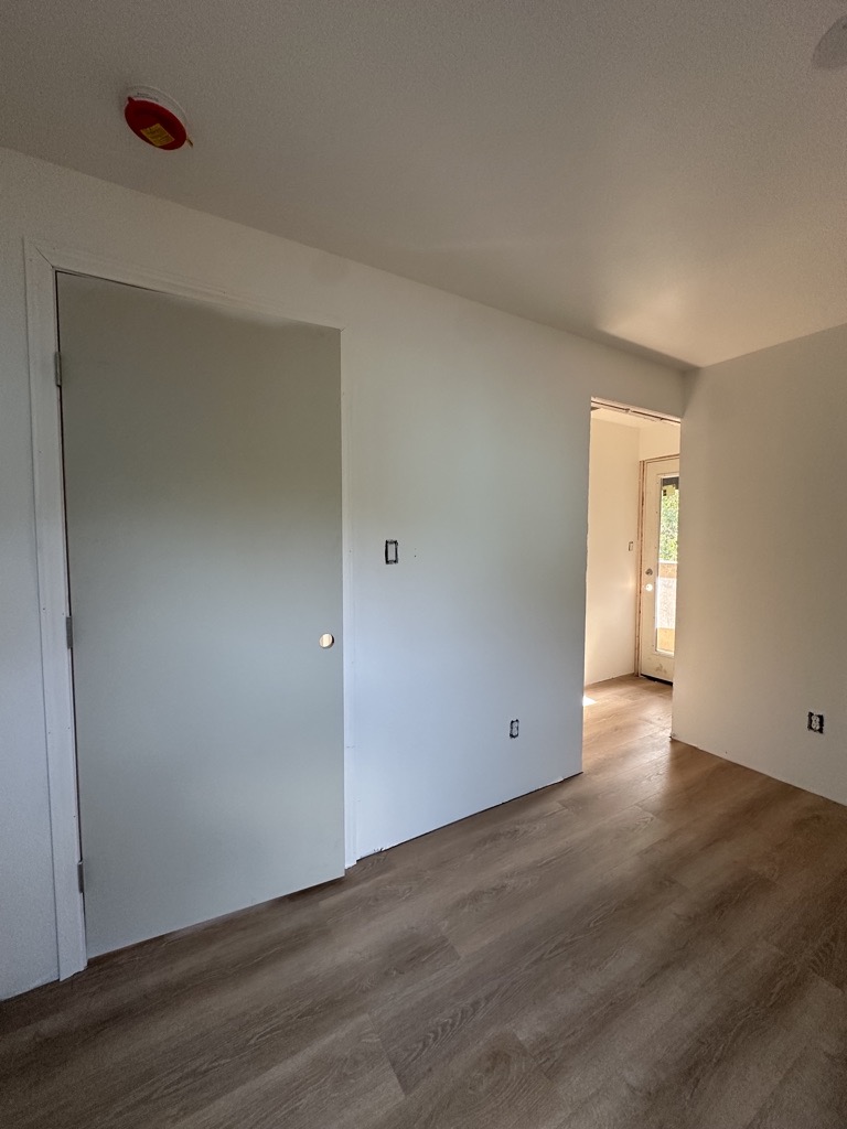 Renovated room · LVP and painted surfaces — Austin house flip by Kir Remodeling