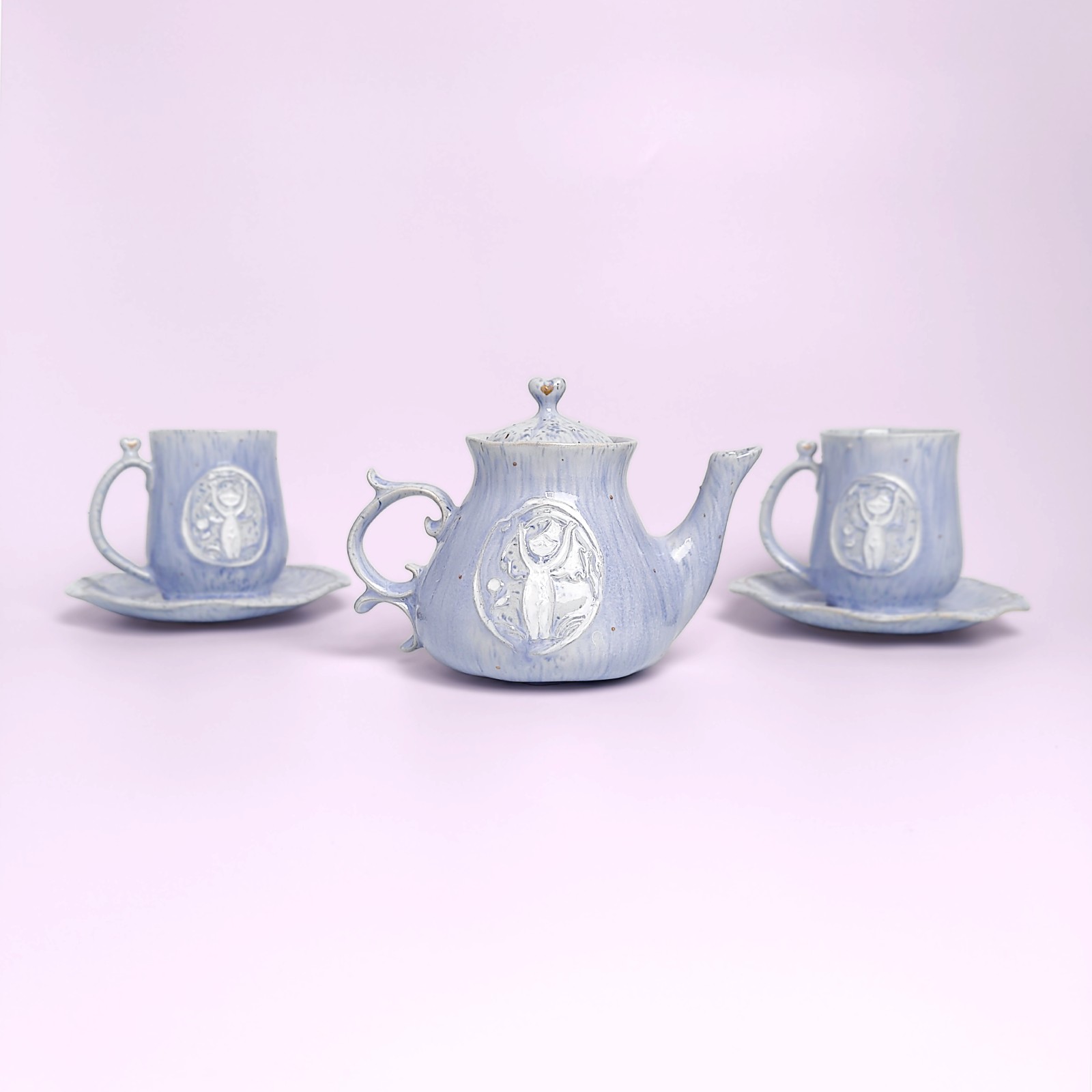 delicate blue handmade tea set — teapot, cups and saucers with carved forest fairy medallions