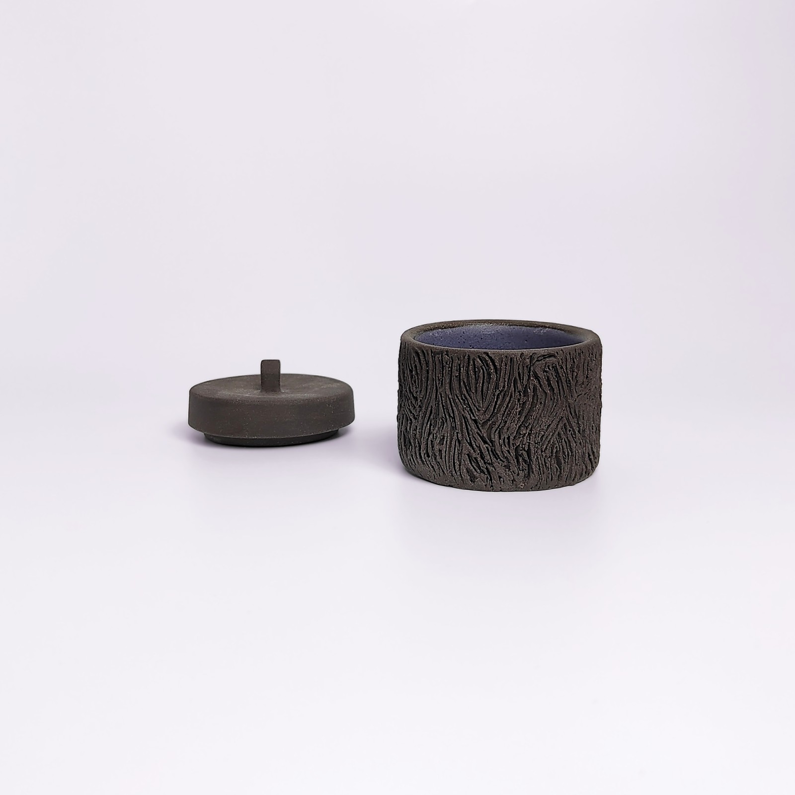 dark witchy-style ceramic box with carved wood-like texture and mystical violet glaze