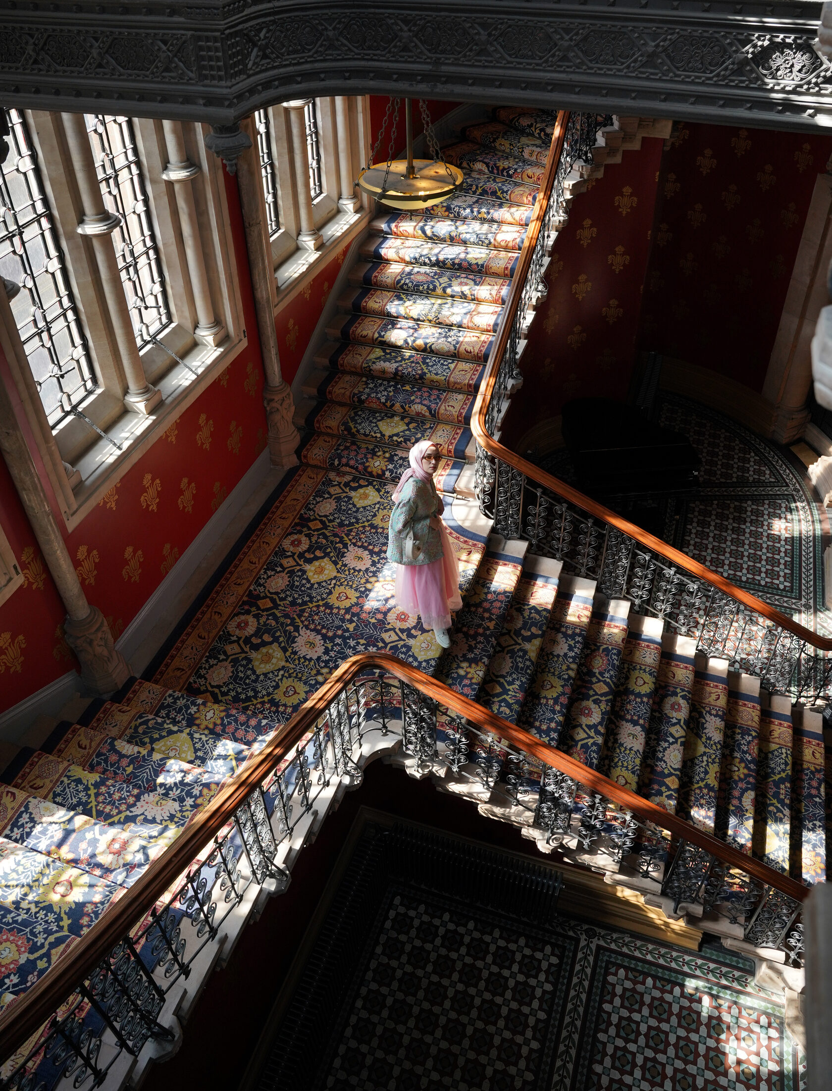 Portrait on an ornate staircase photographed from above