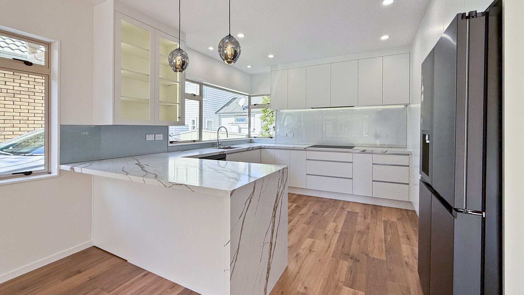 Renovated St Heliers kitchen and stone-look peninsula