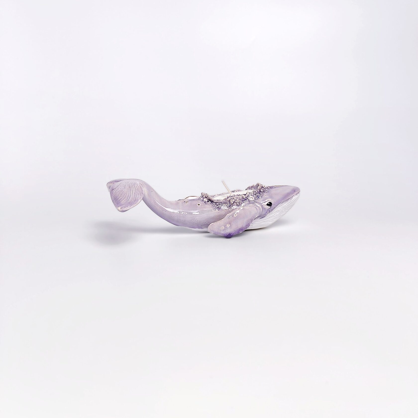 handmade ceramic candle holder shaped like a purple whale with sculptural details