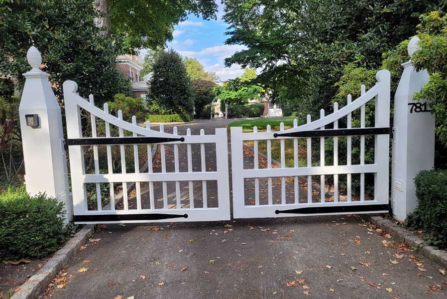 Traditional colonial entry gate with iron strap hinges 