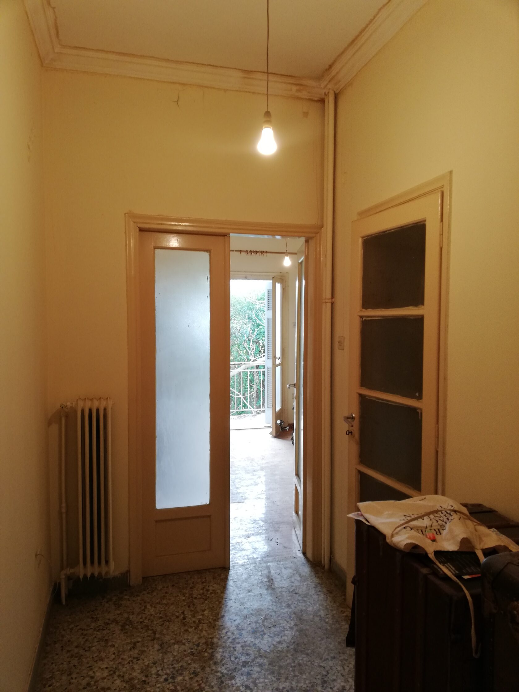 Bedroom before renovation, dark curtains, dated carpet